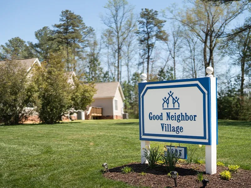 Good neighbor village cottage and welcome sign