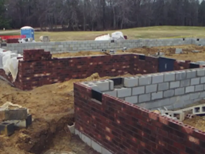 Bricks being laid to build cottage 