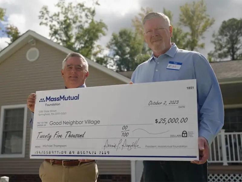 MassMutual presenting check to Good Neighbor Village board member
